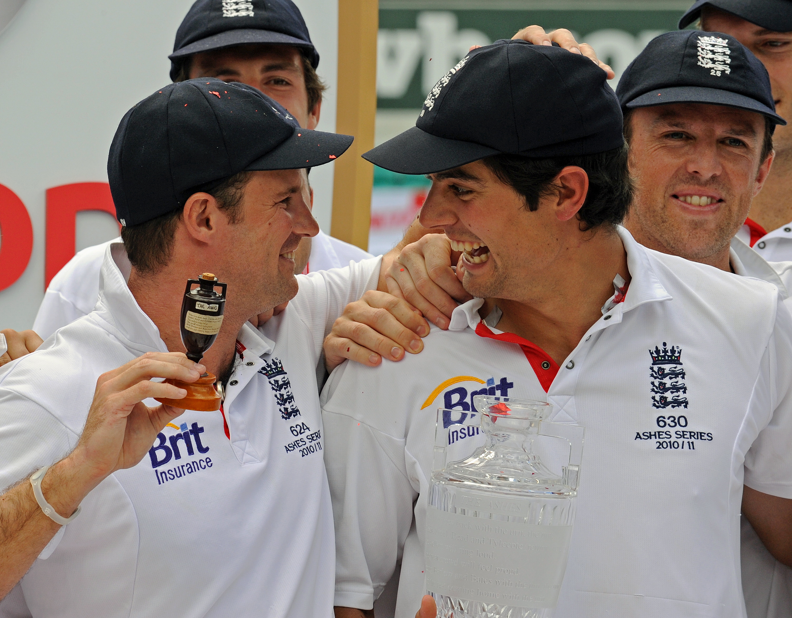 England’s Andrew Strauss (L) holds up th