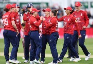 England Women T20 team celebrate taking a wicket. 